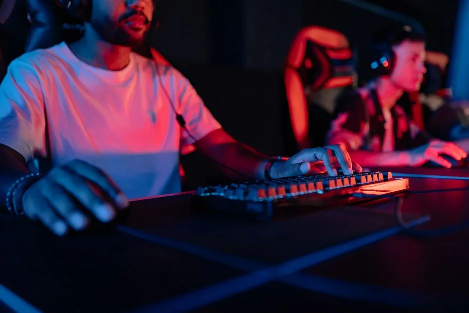 CS2 players competing at illuminated gaming stations on a large LAN tournament stage in Riyadh