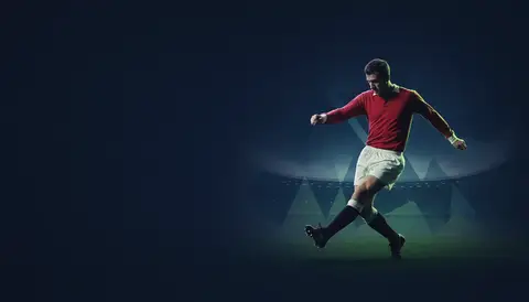 Nobby Stiles photographed during his playing career at Manchester United, footballer mid-action in period kit